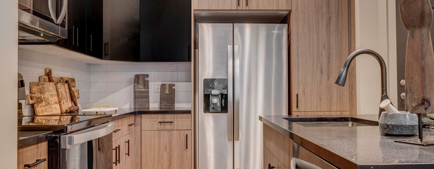 a kitchen with a stainless steel refrigerator
