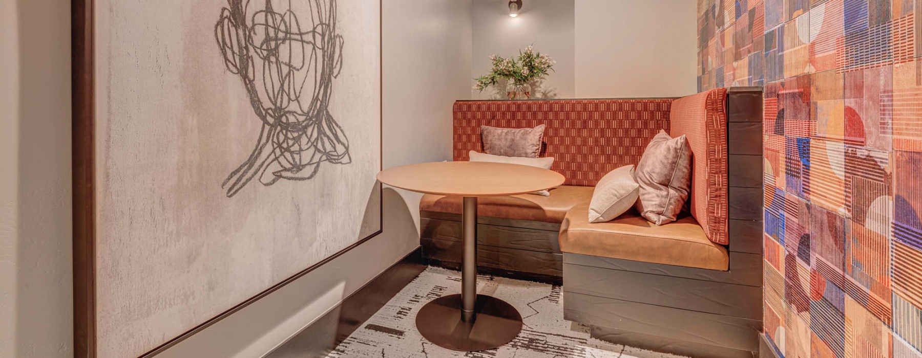 a room with a table and large painting